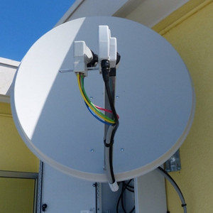 Parabola satellitare dual feed con convertitore ad uscita VH-VH e convertitore ad uscita in fibra ottica.