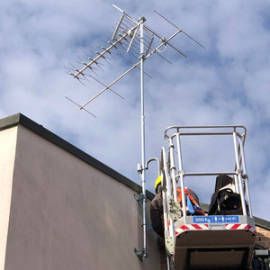Addetti Tesser Antenne in installazione impianto di antenna tv su parete con utilizzo cestello elevatore.